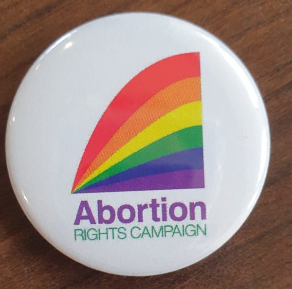 a badge with the ARC logo in pride colours